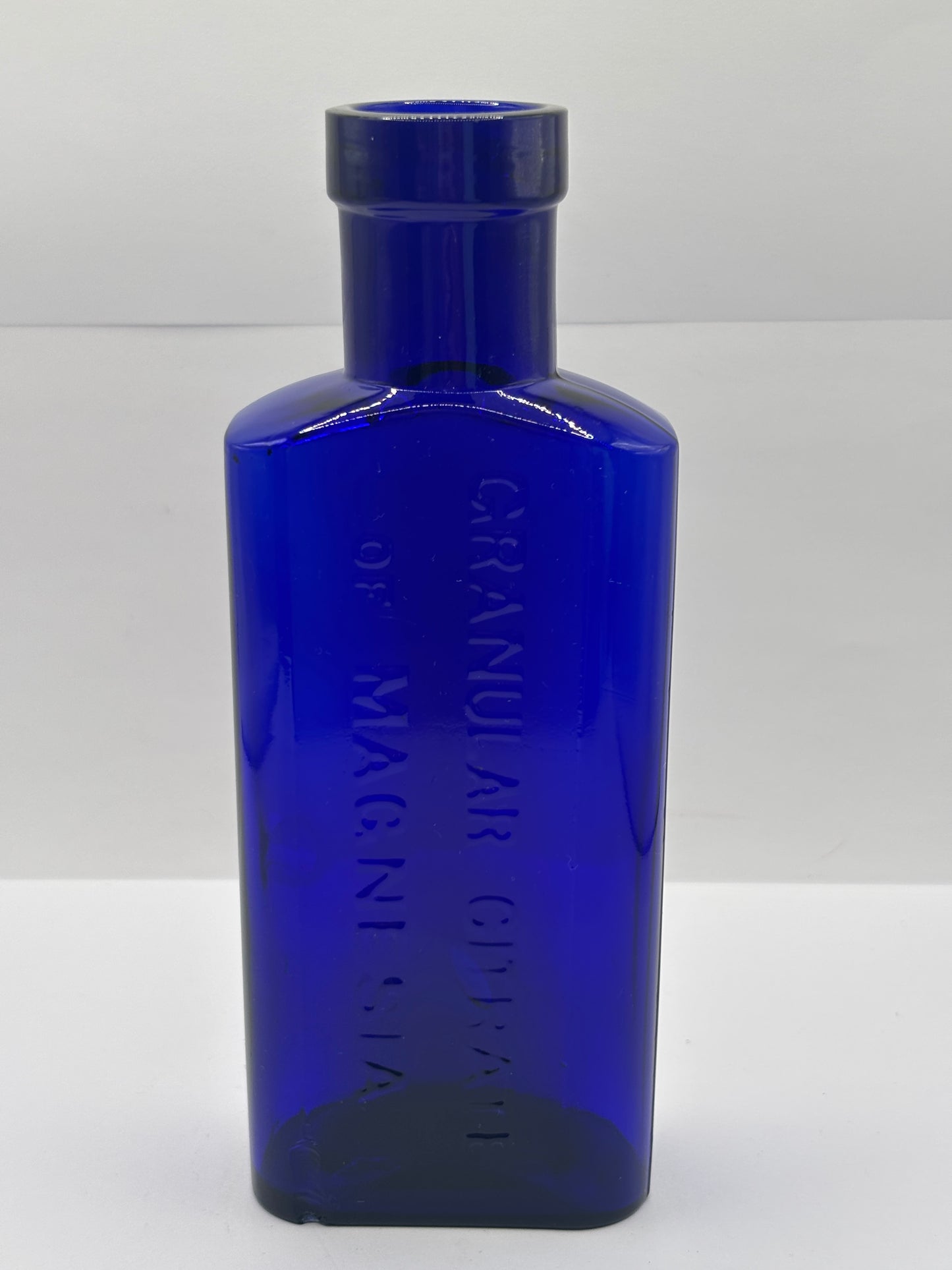 Old blue glass advertising bottle, Granular citrate of magnesia