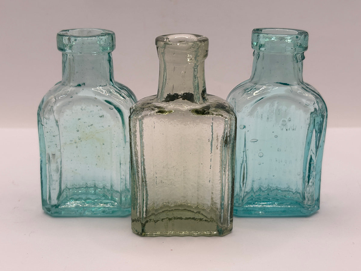 3 small aqua glass bottles