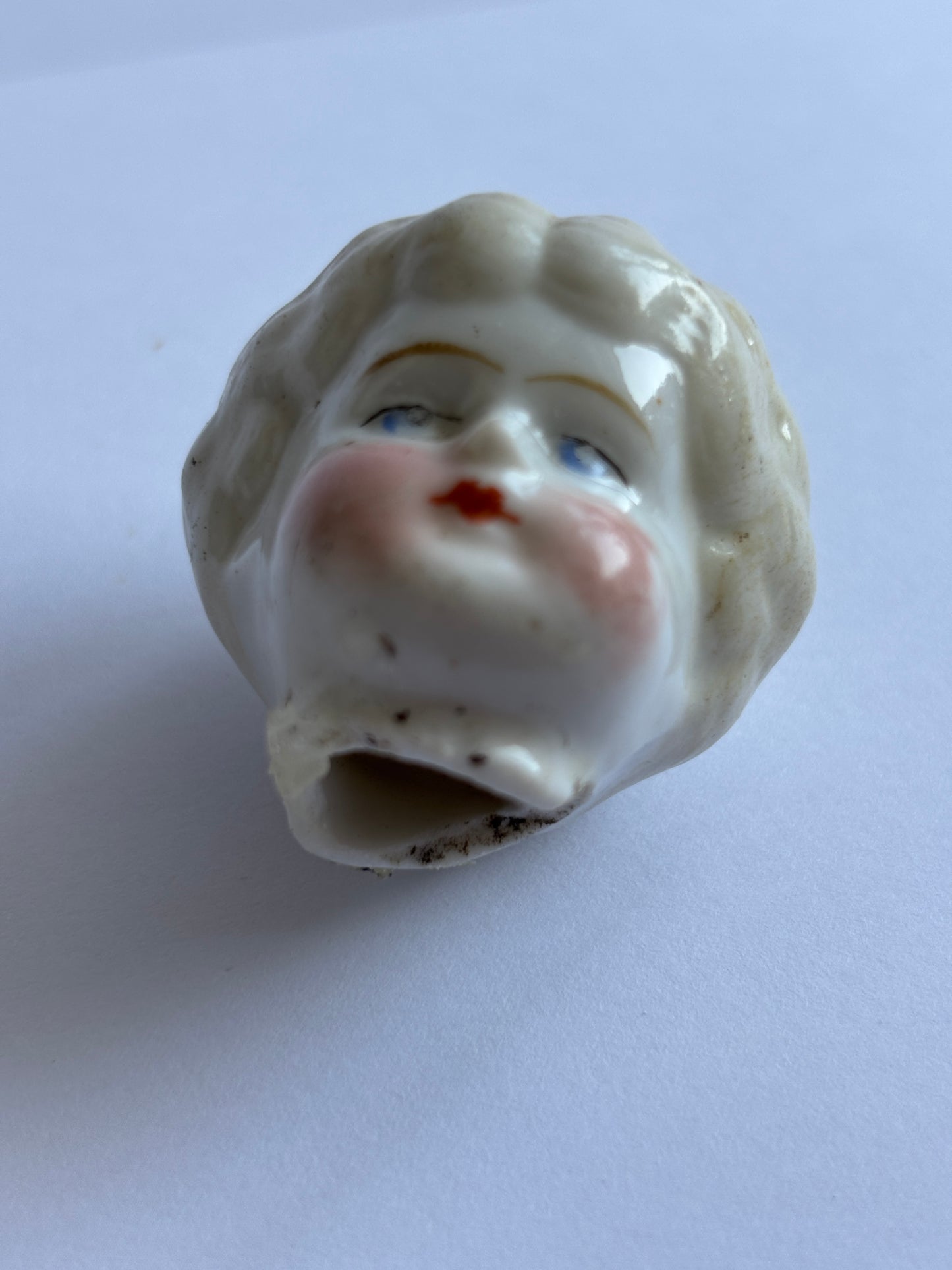 Old small damaged dolls head