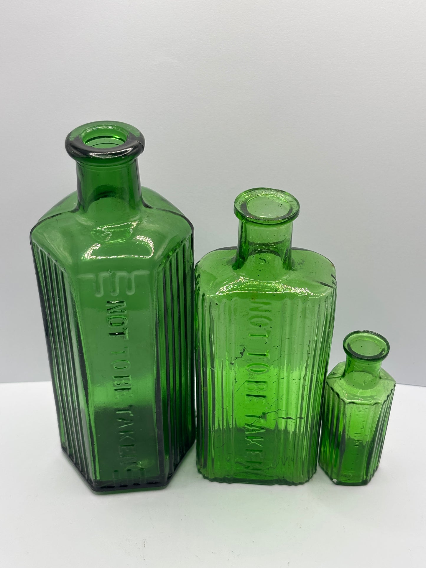 3 old green glass poison bottles, not to be taken