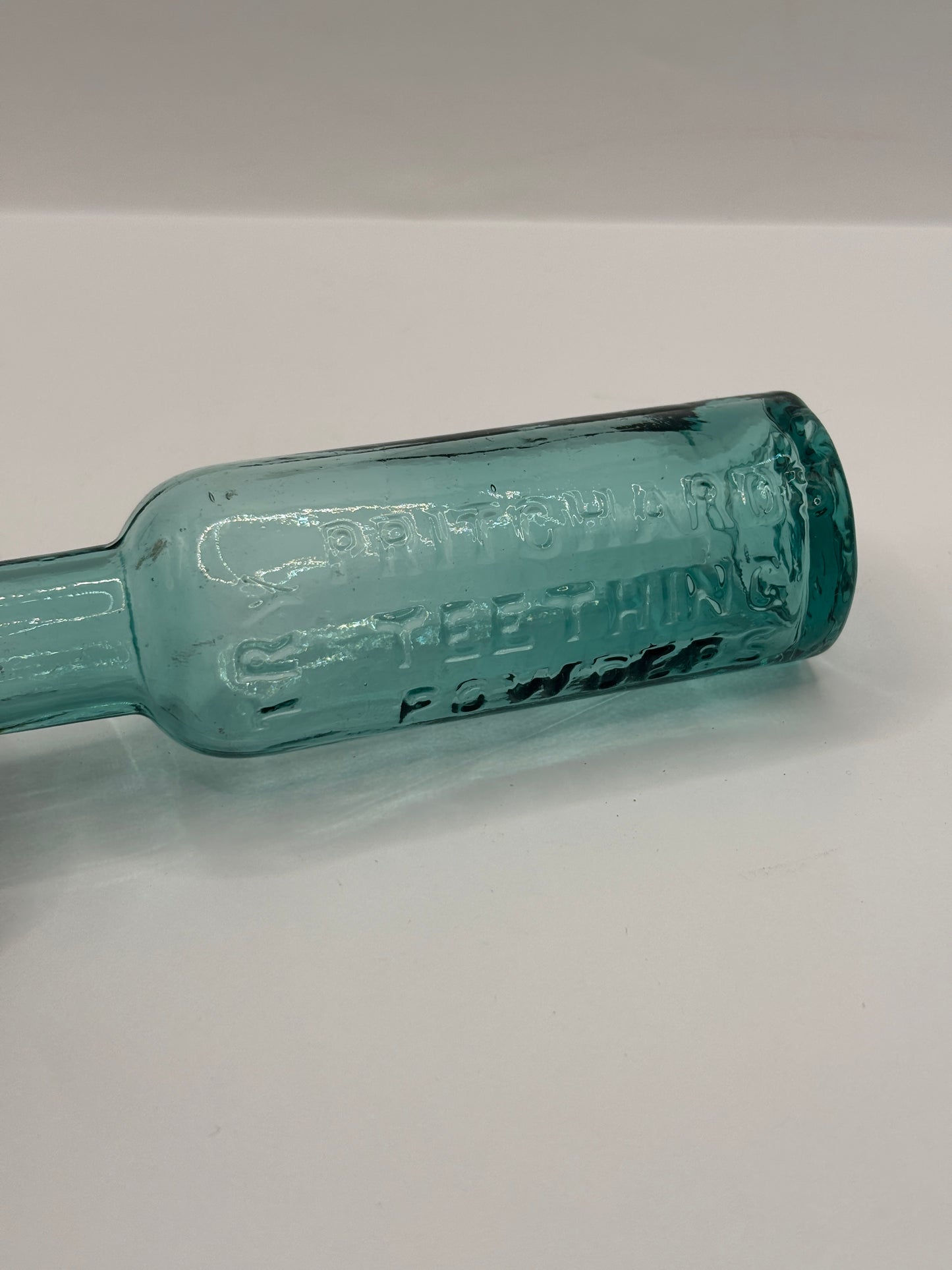 Old aqua glass advertising bottle. Pritchards teething powders
