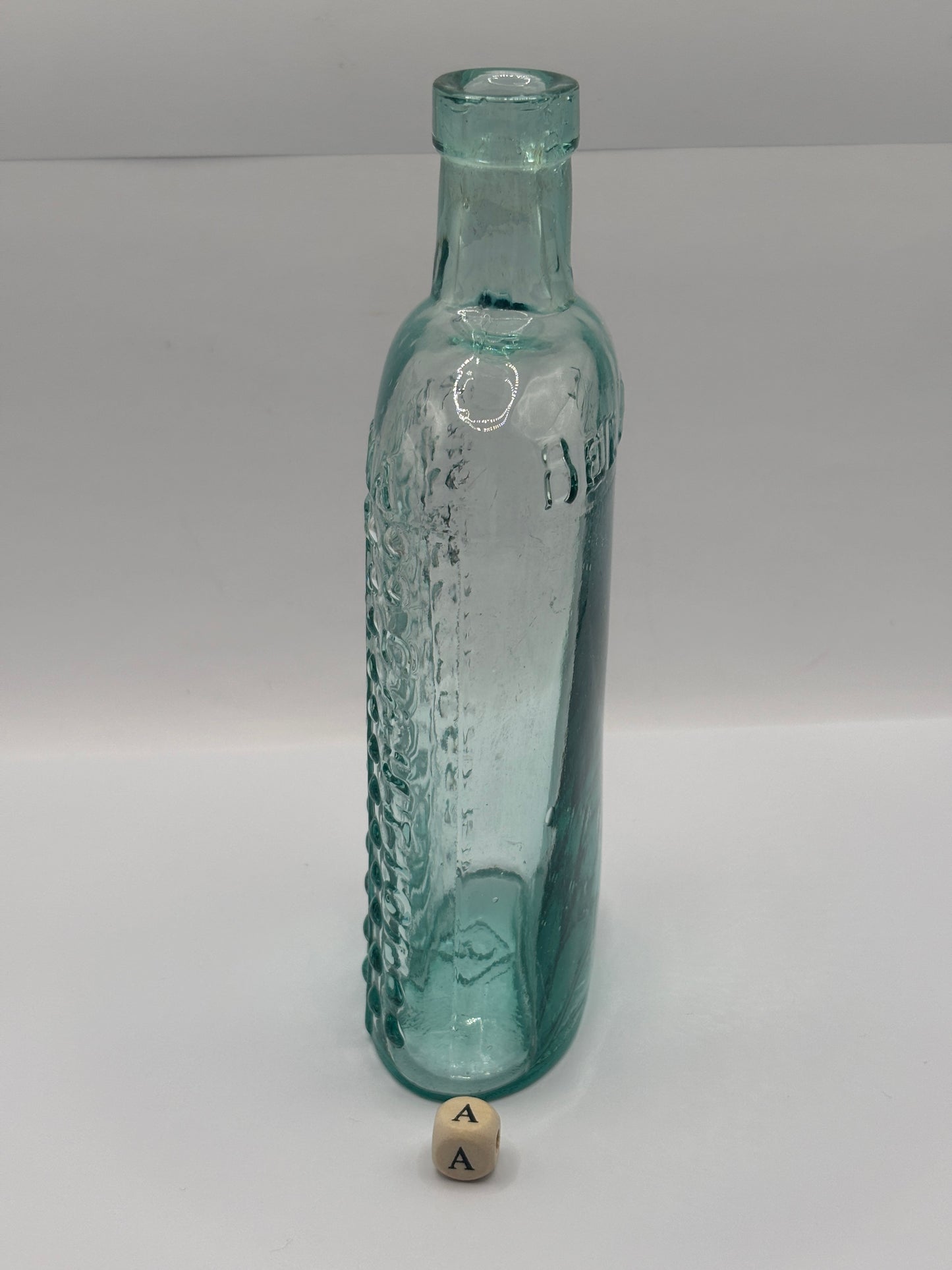 Old aqua glass poison bottle, (a) ammonia, poisonous