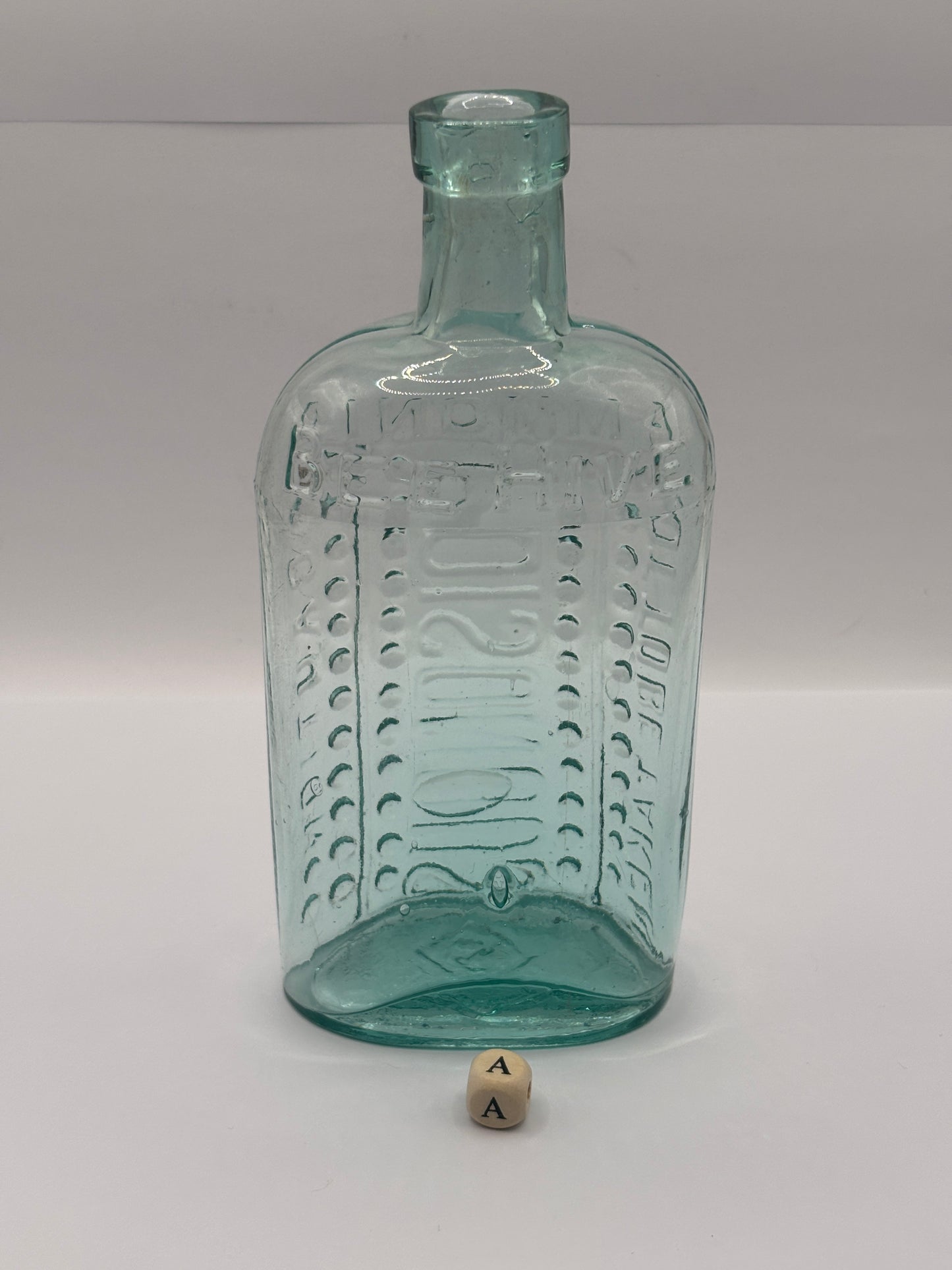 Old aqua glass poison bottle, (a) ammonia, poisonous