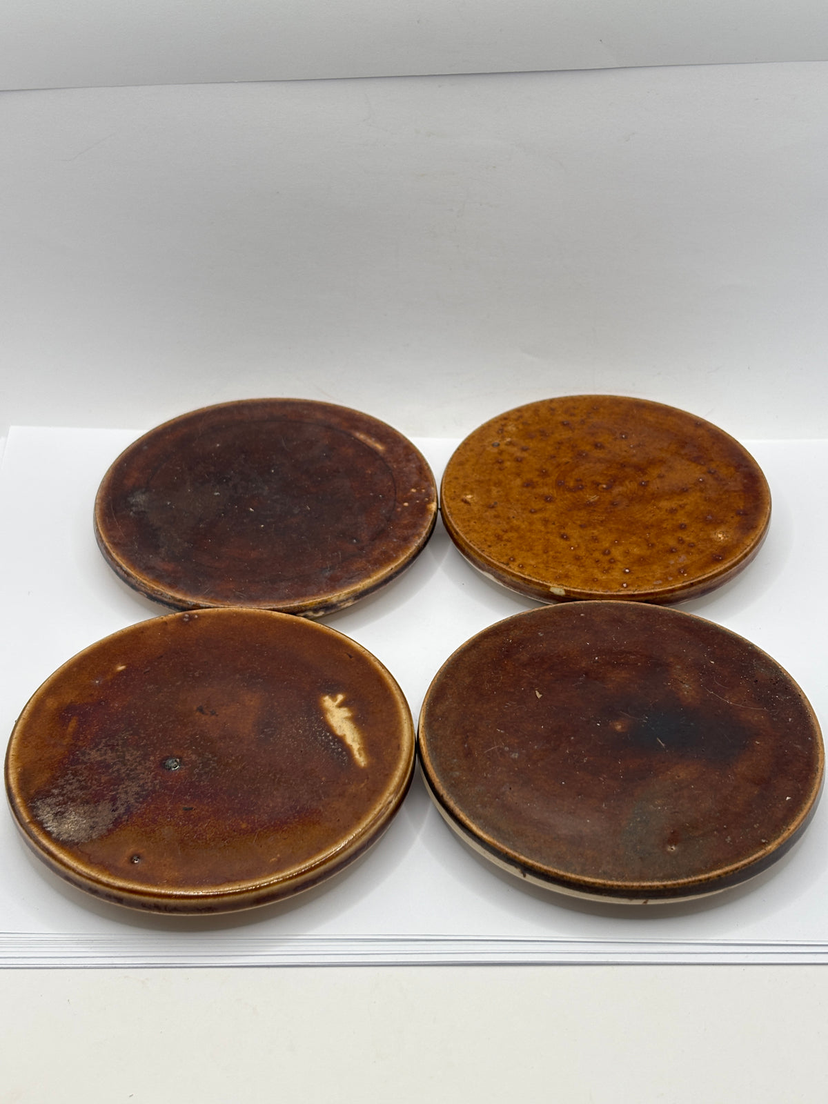 4 old brown stoneware lids, stackers
