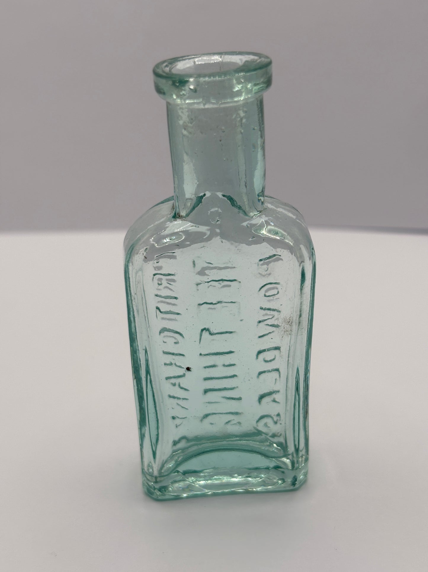 Old aqua glass advertising chemist bottle. Pritchards teething powder