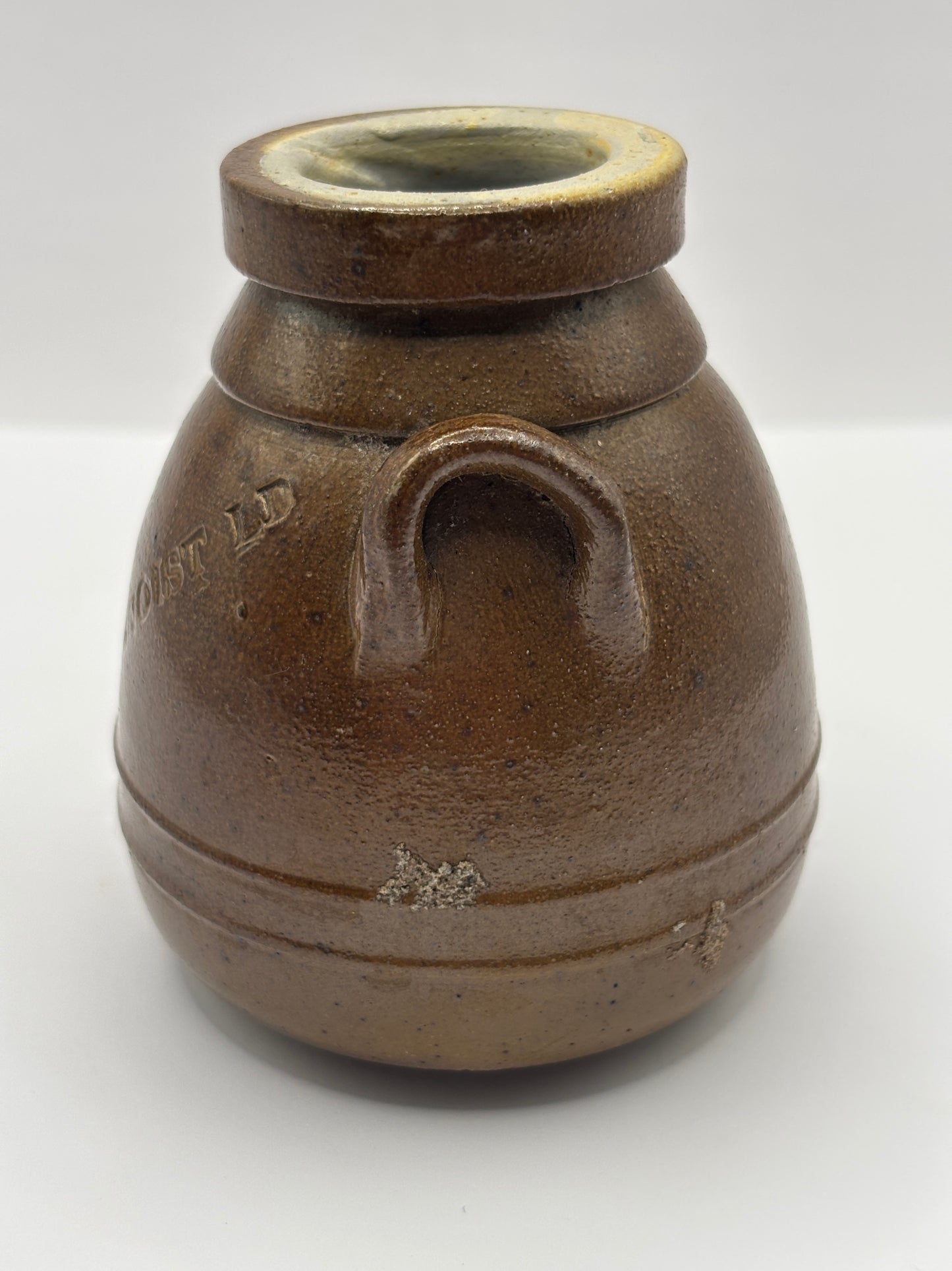 Old brown stoneware Benoist jar