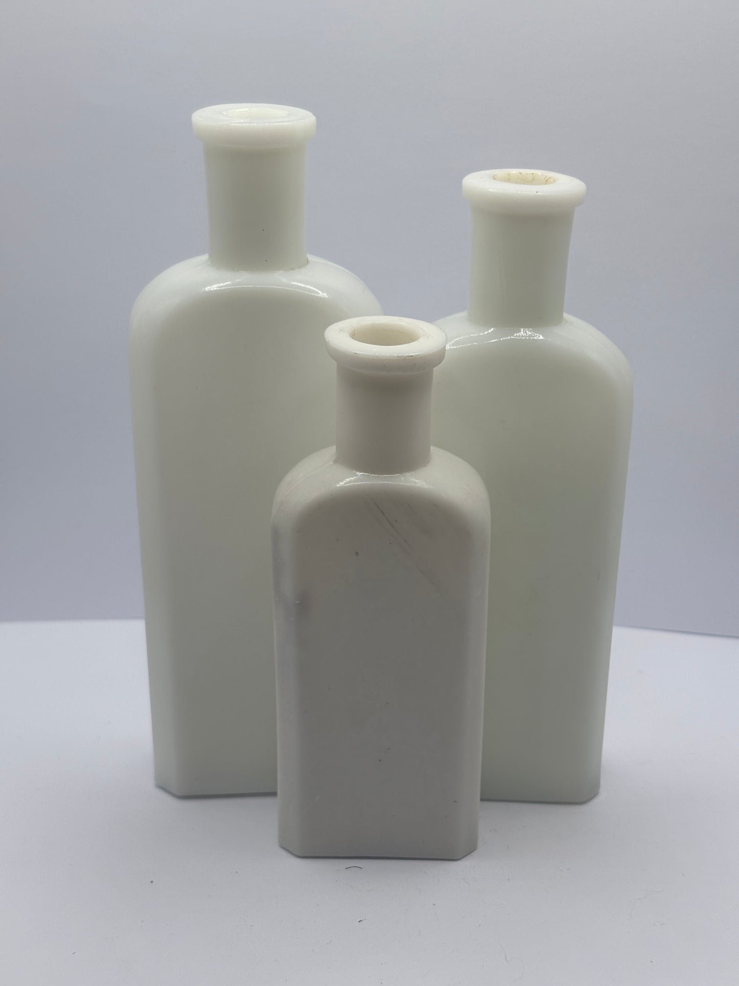 3 old white milk glass bottles