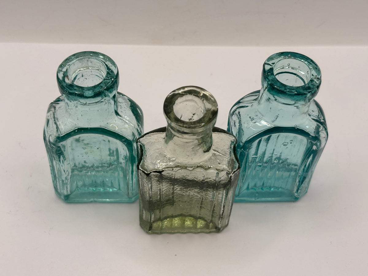3 small aqua glass bottles