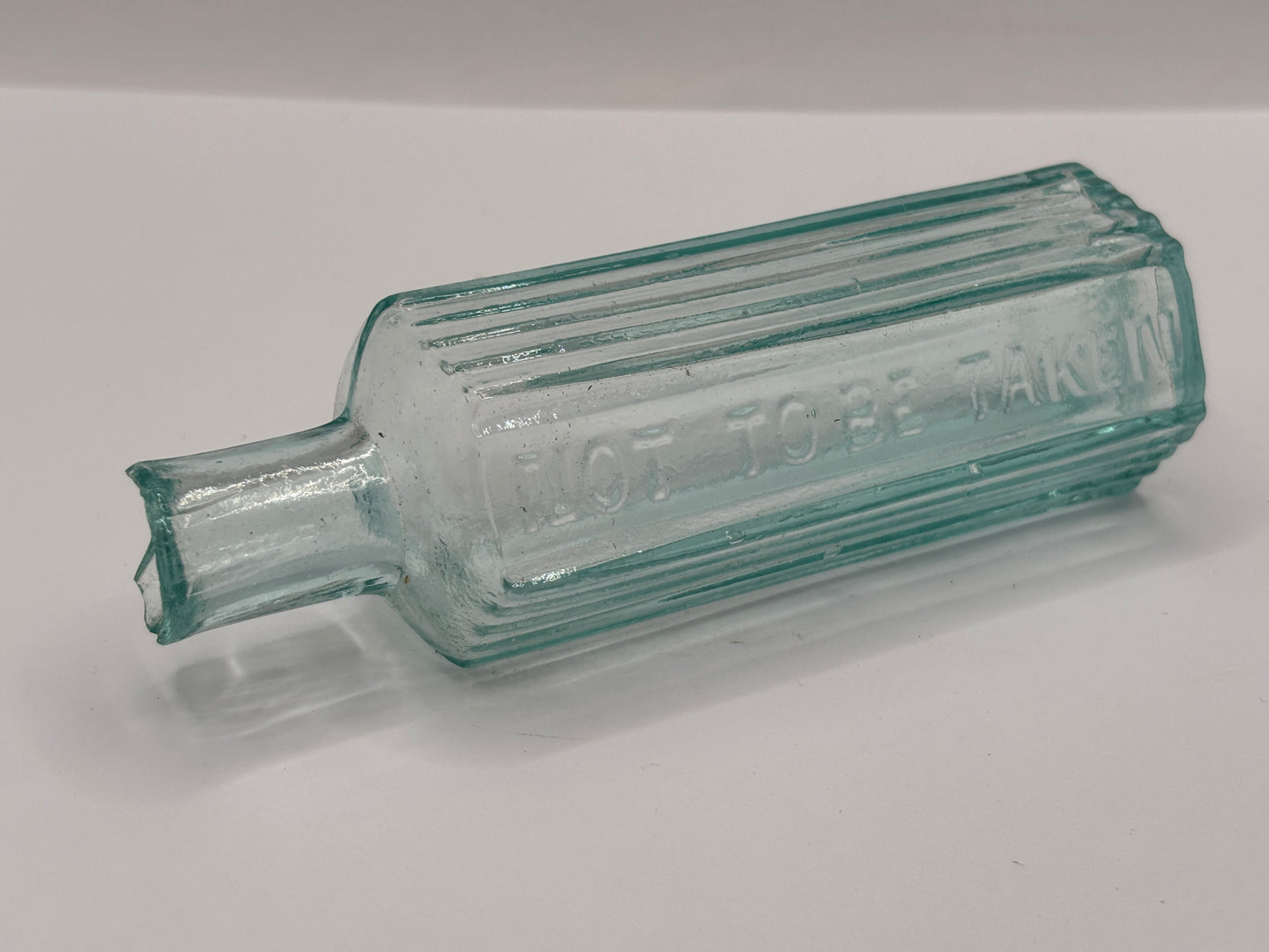 Old aqua glass poison bottle, not to be taken