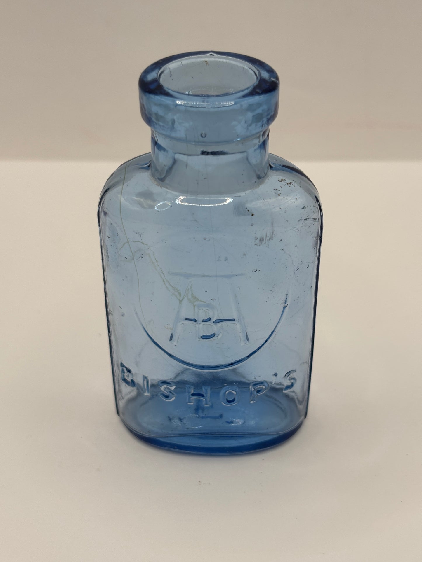 Old small blue glass advertising chemist bottle, Bishop