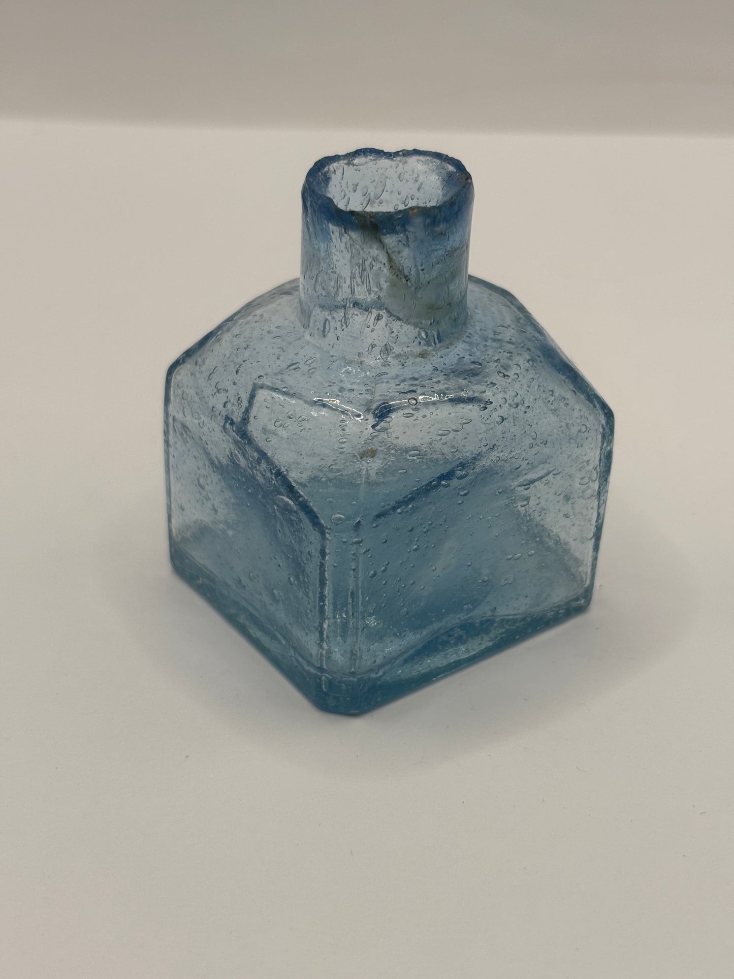 Old blue glass inkwell, ink bottle, penny ink. Lots of air bubbles