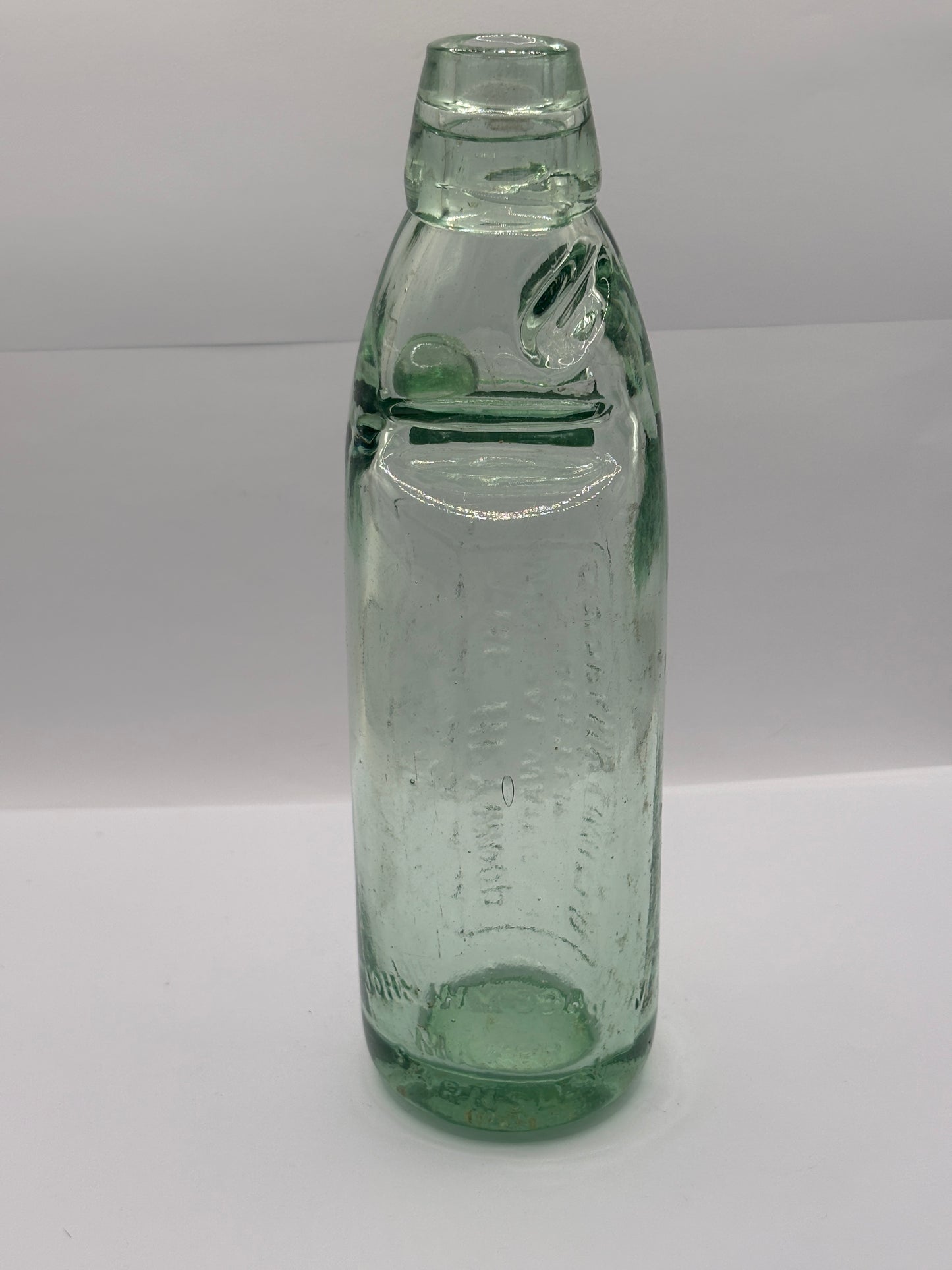Old glass codd bottle, with marble. The Heywood mineral water bottling co