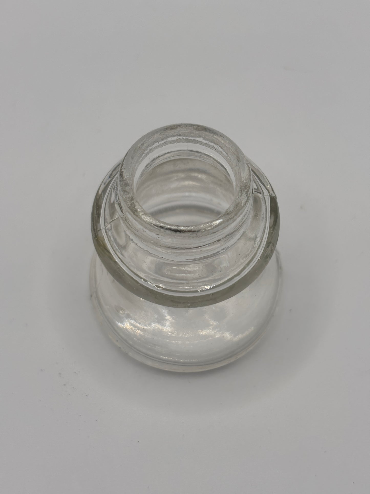 Old clear glass inkwell, ink bottle