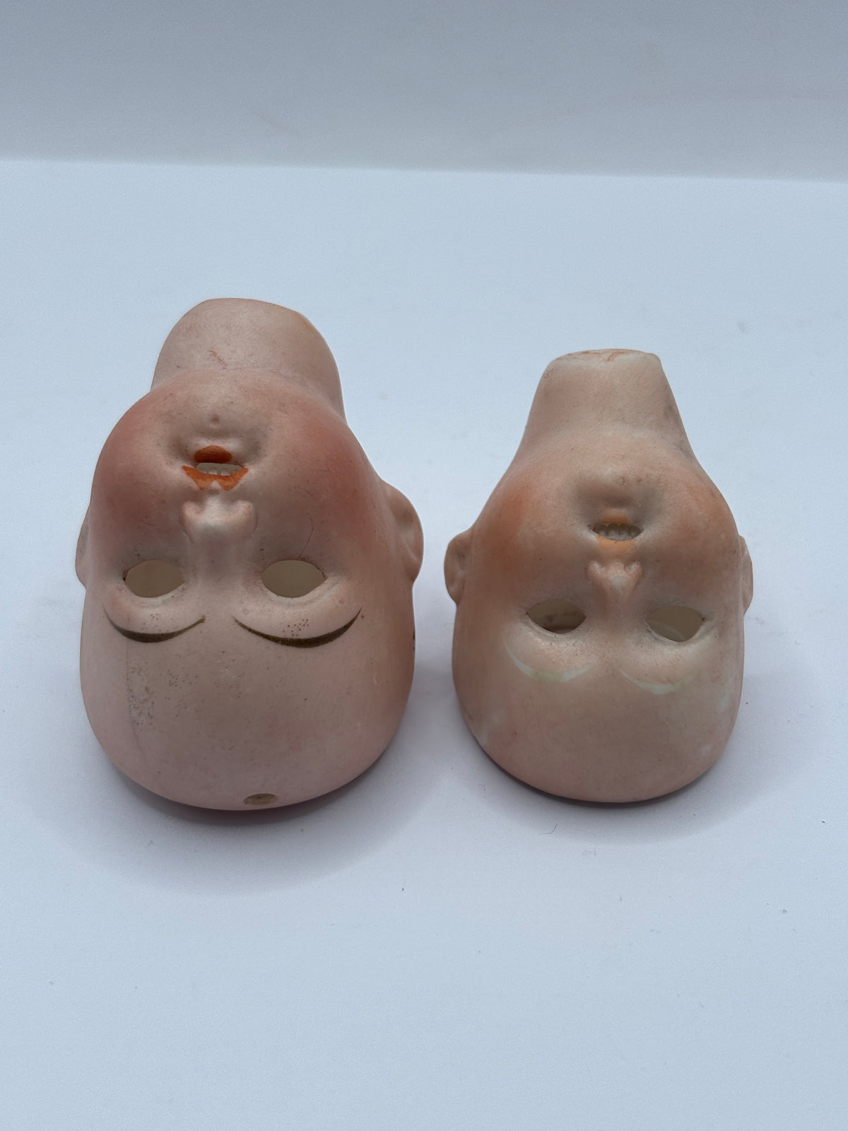 2 Old small bisque dolls heads. Damaged
