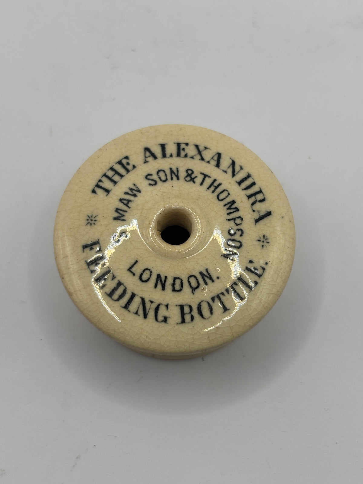 Old advertising baby feeder lid, Alexandra feeding bottle lid