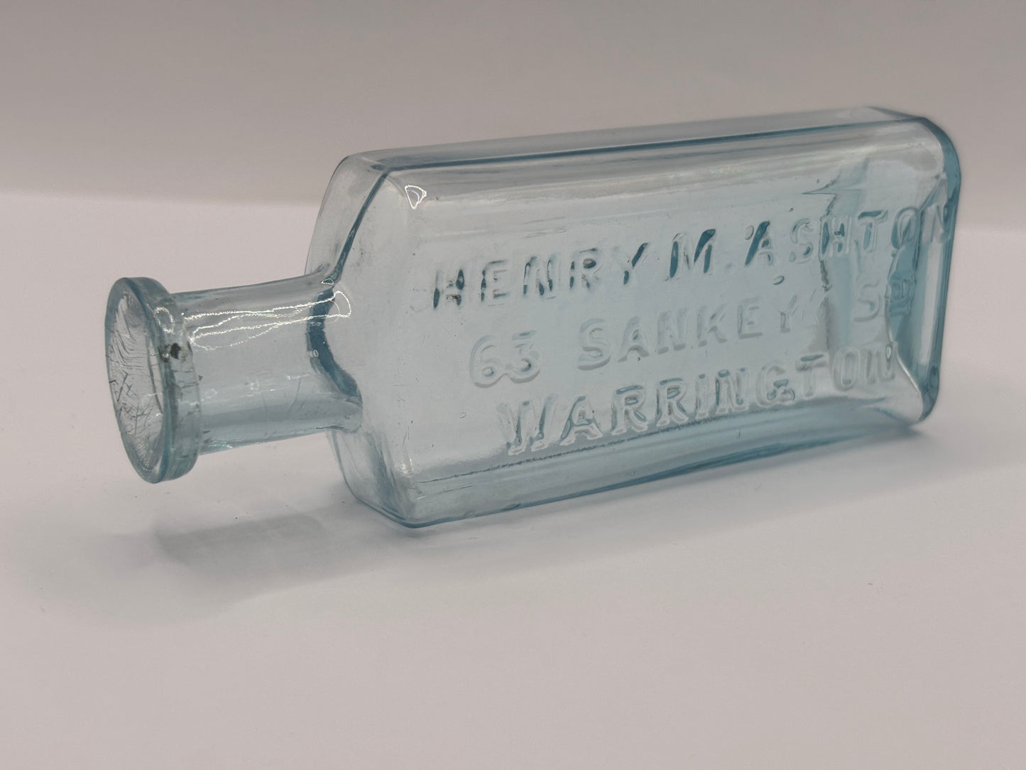 Old glass advertising chemist bottle, Warrington