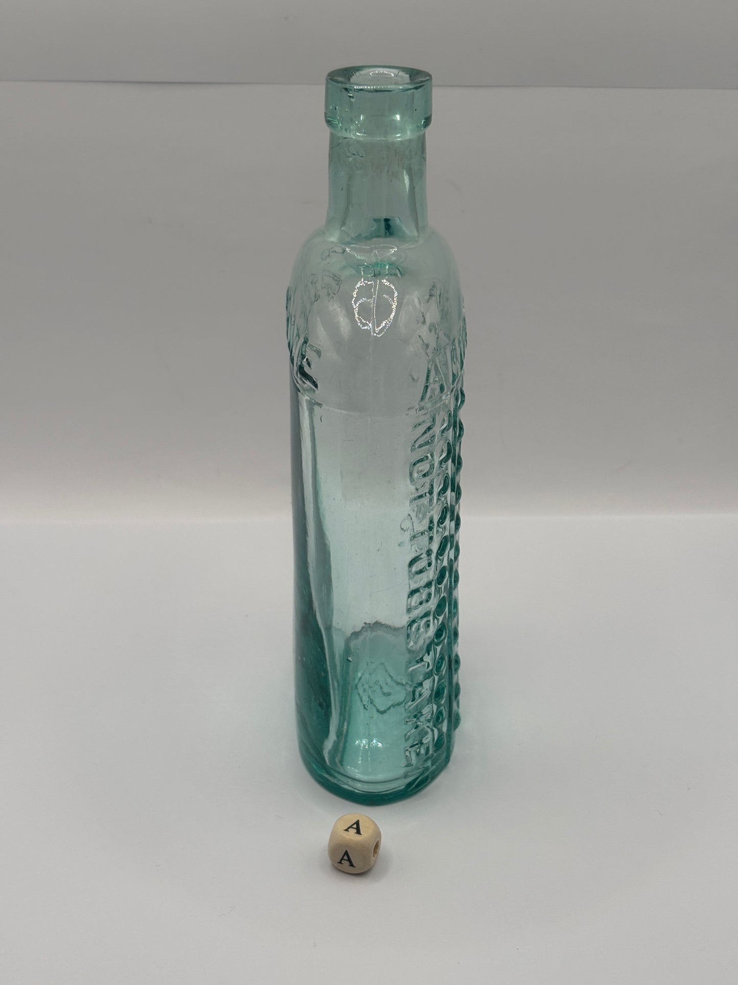 Old aqua glass poison bottle, (a) ammonia, poisonous