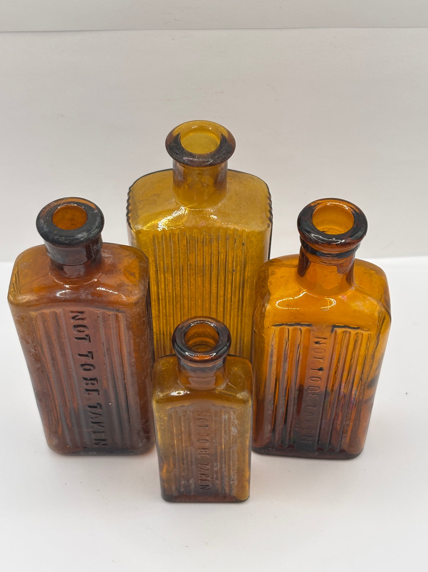 4 crusty Old amber glass poison bottles