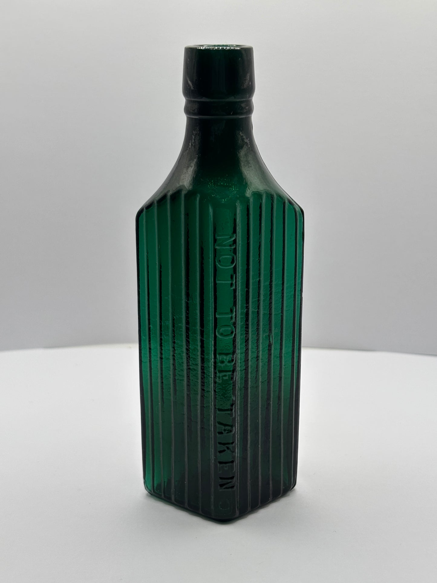 Old green glass poison bottle, not to be taken