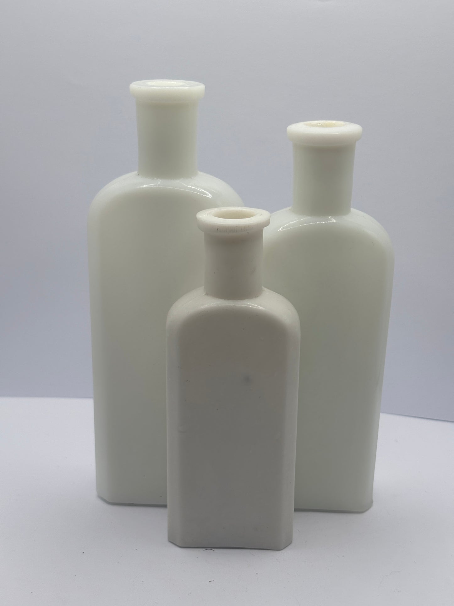 3 old white milk glass bottles