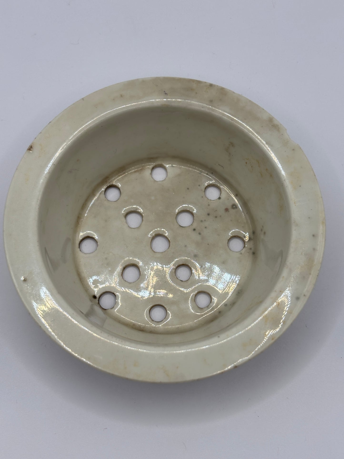 Old stoneware strainer