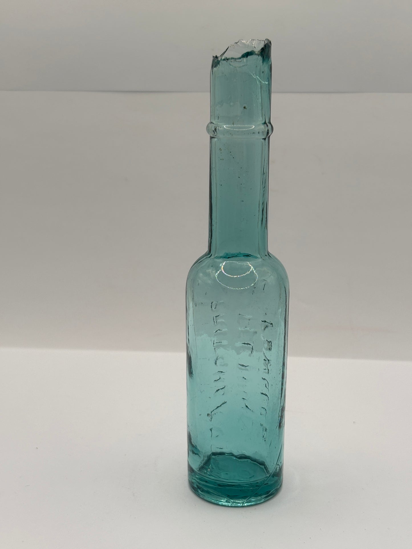 Old aqua glass advertising bottle. Pritchards teething powders