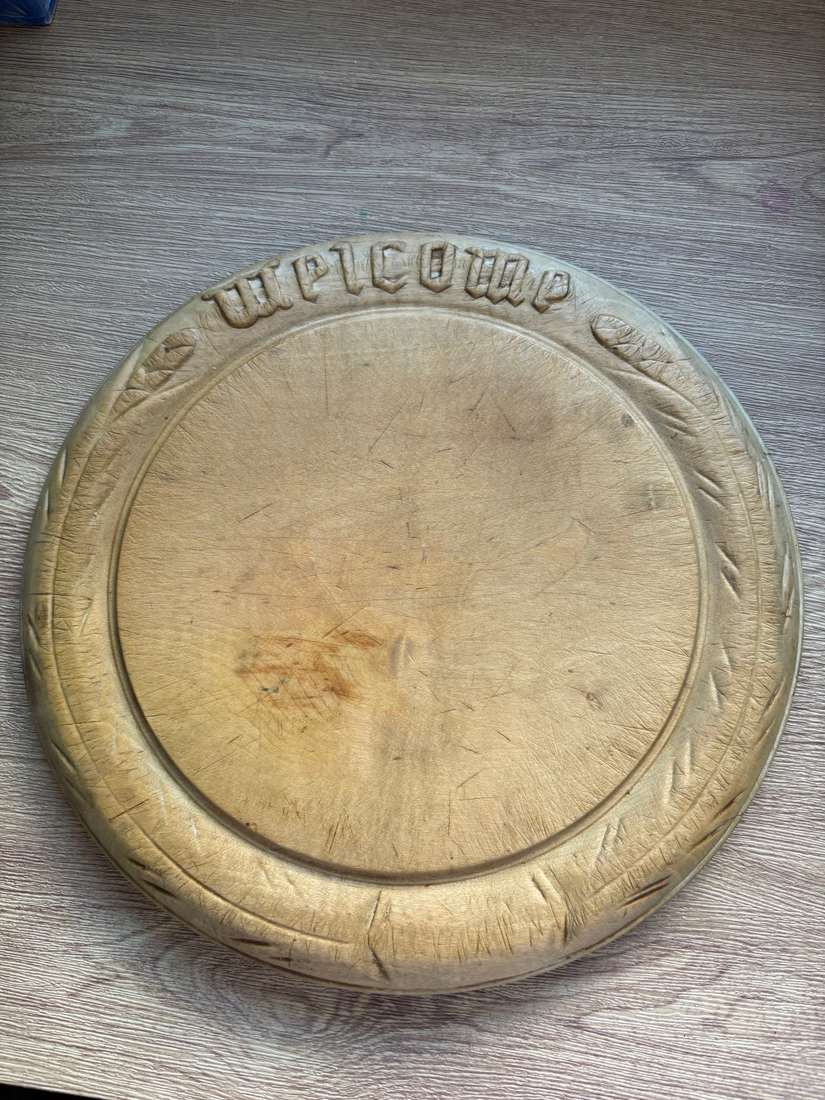 Old wooden carved bread board “welcome”
