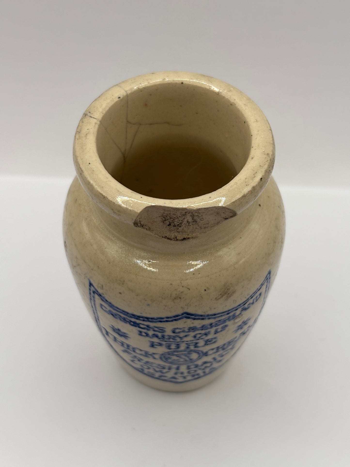 Old advertising cream pot, Carricks pure thick cream. Damaged