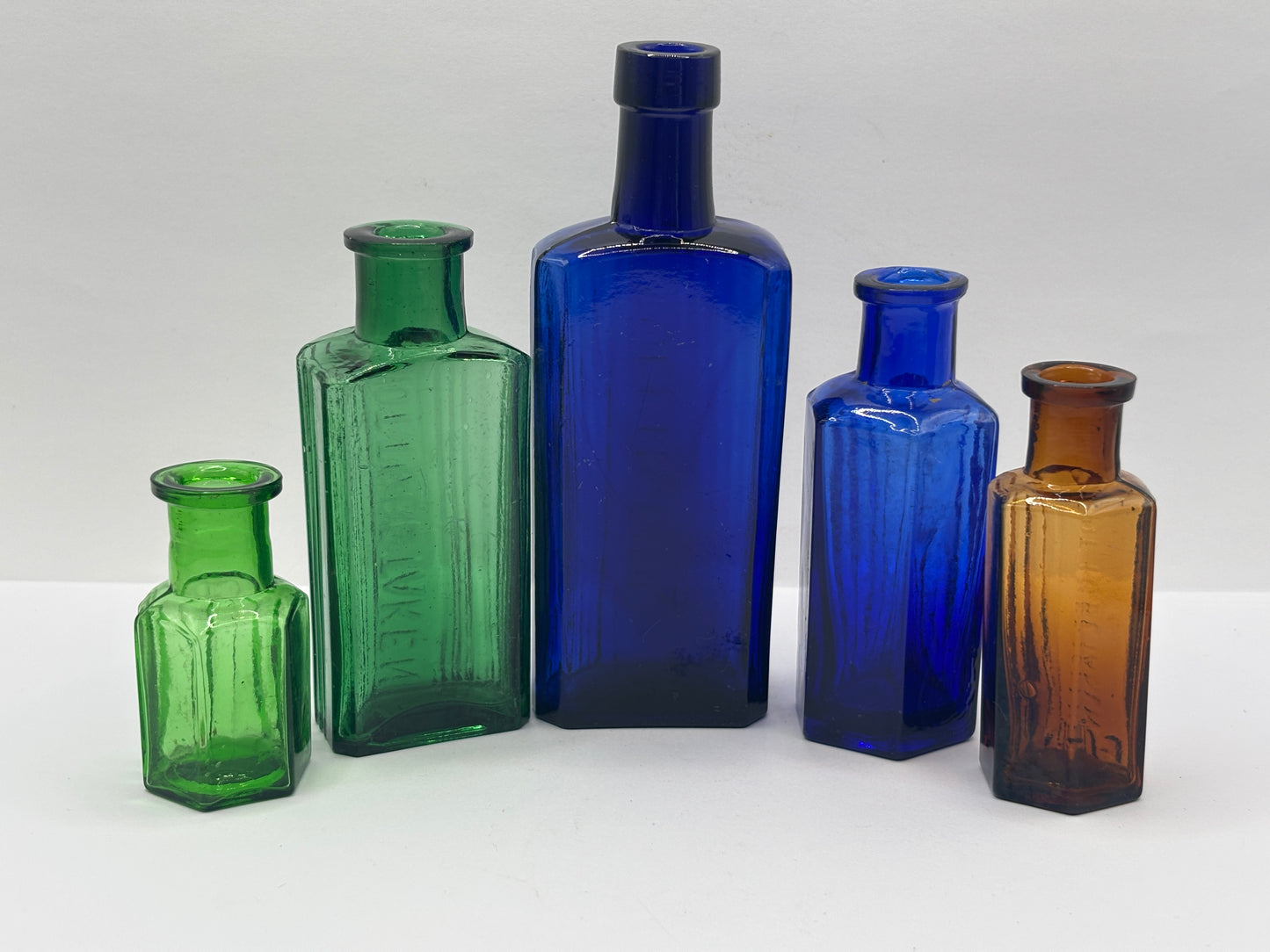 5 old glass poison bottles, not to be taken