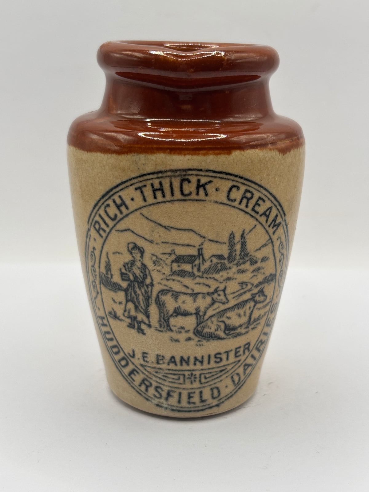 Old advertising cream pot, Bannisters Huddersfield dairies. Repaired handle