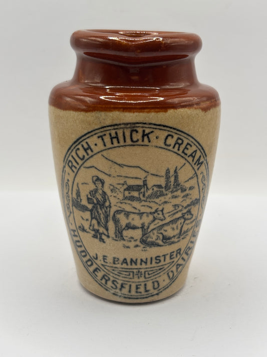 Old advertising cream pot, Bannisters Huddersfield dairies. Repaired handle