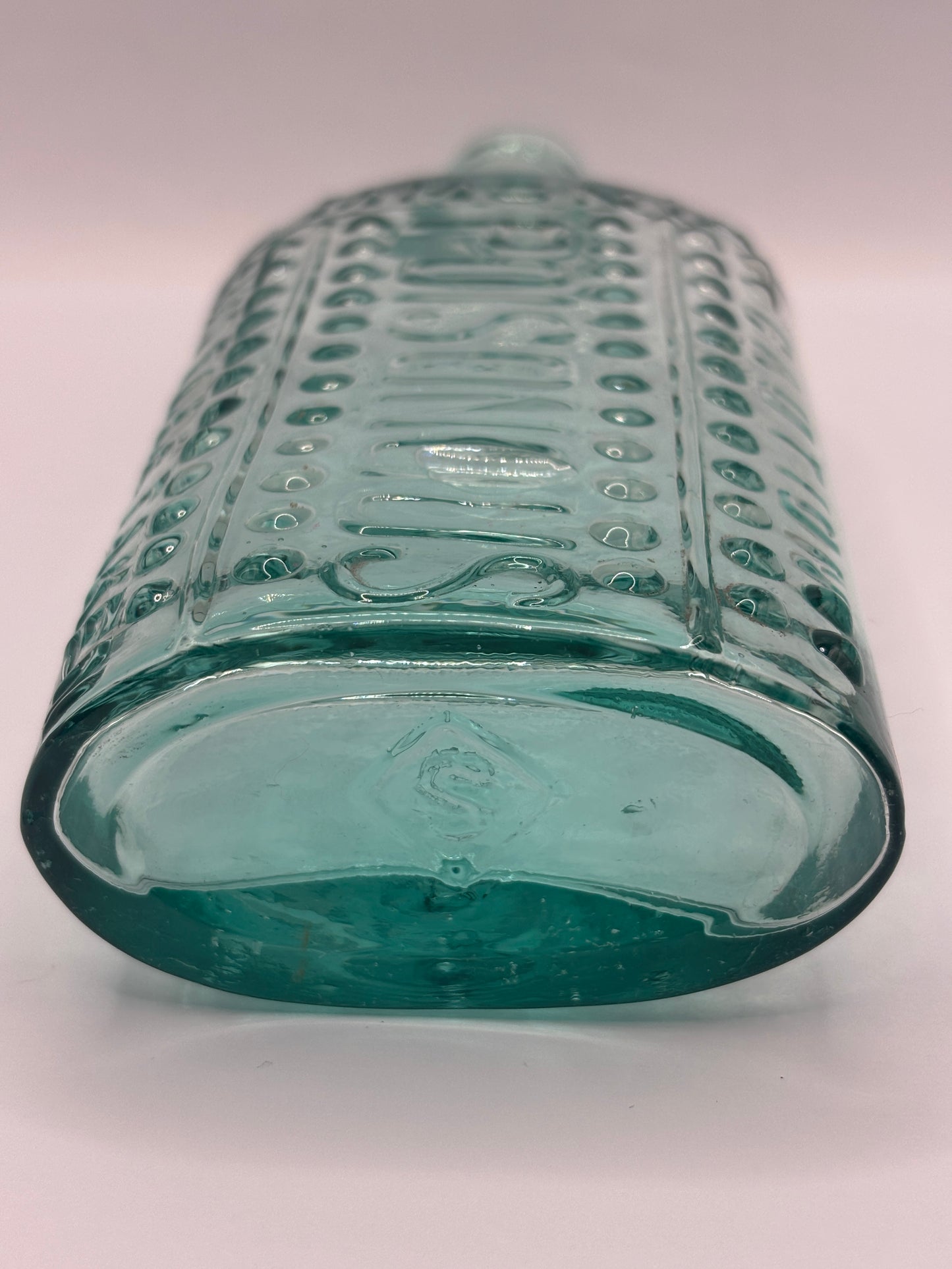 Old aqua glass poison bottle, (a) ammonia, poisonous