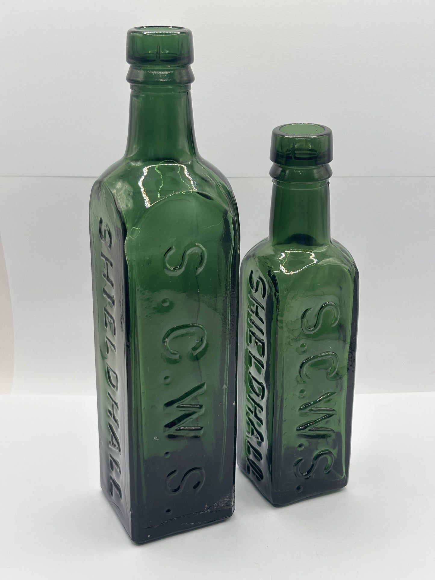 2 old dark green essence of coffee and chicory bottles