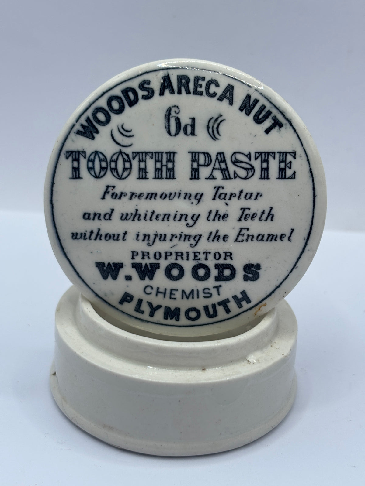 Old advertising lid and base. Woods areca nut tooth paste. Damaged