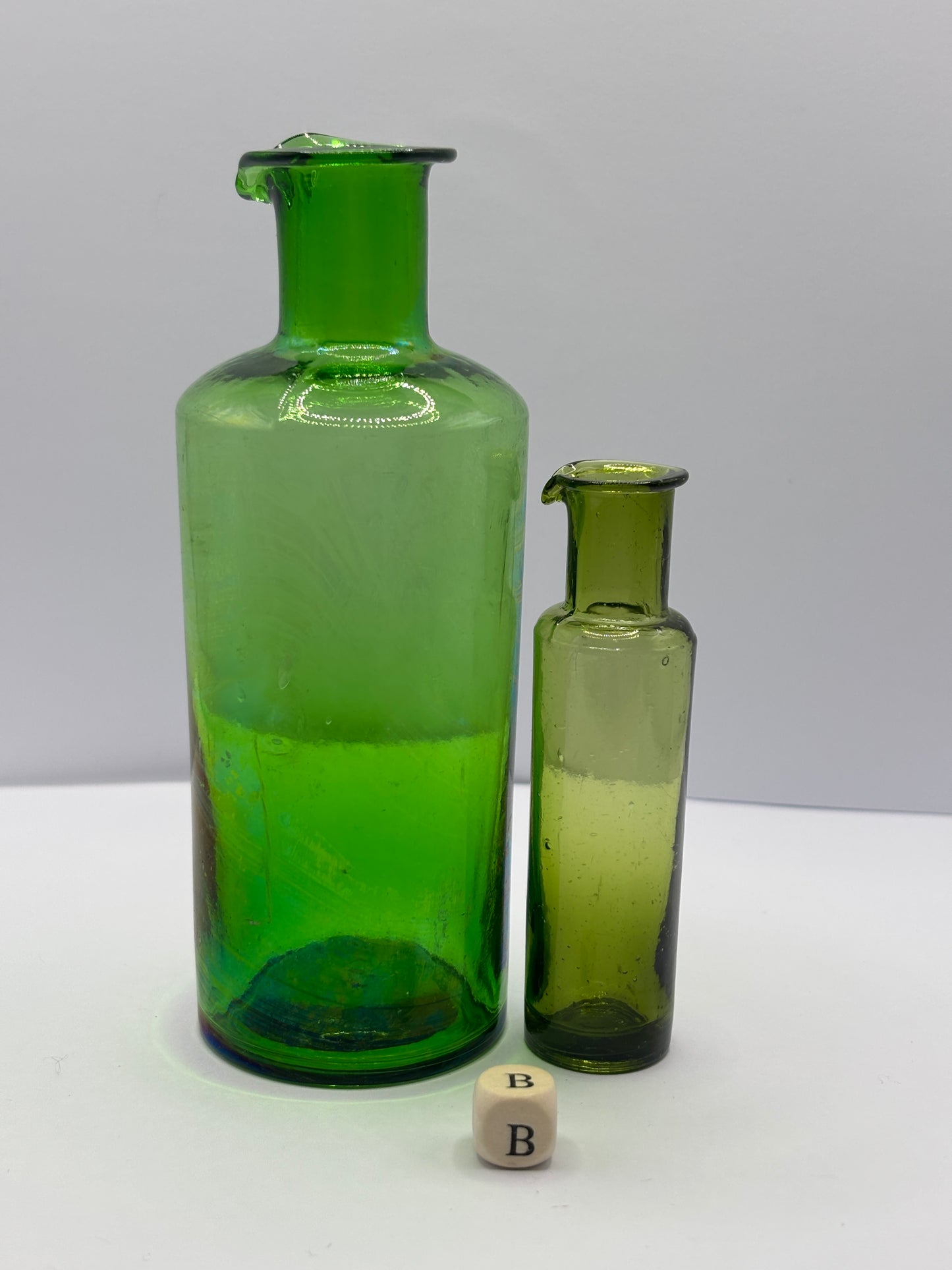 2 old green glass bottles with pouring lips (B)