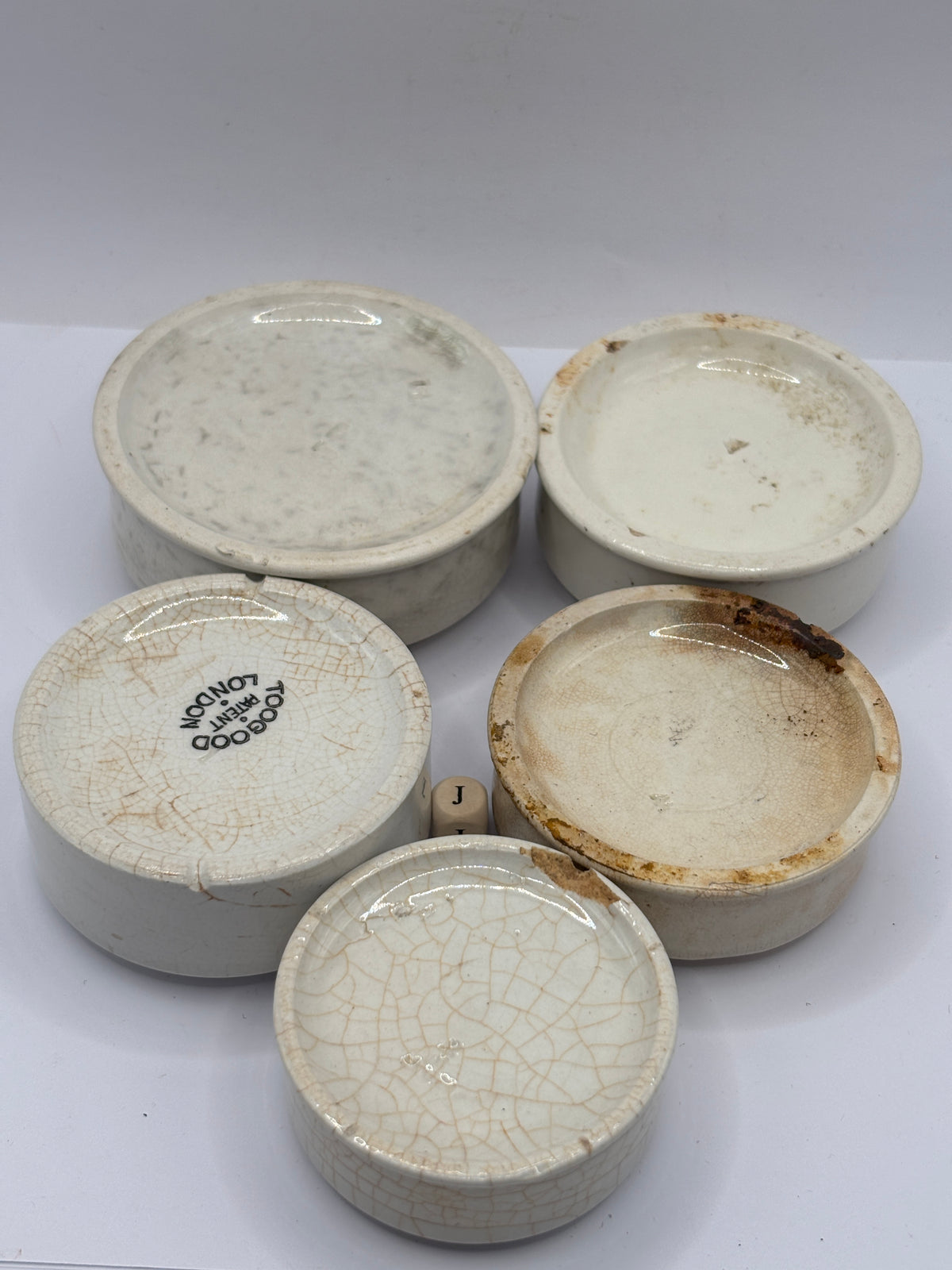 5 old stoneware pot lid bases, stackers (J)