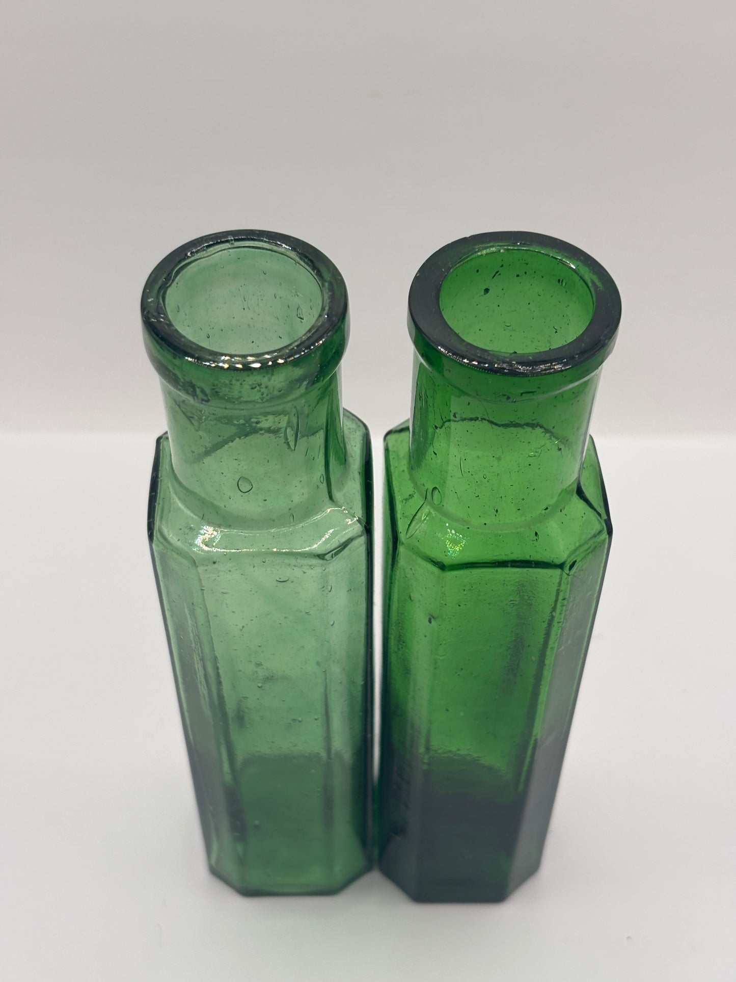 2 old green glass bottles