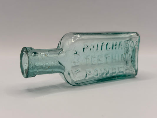 Old aqua glass advertising bottle. Try Pritchards teething powders
