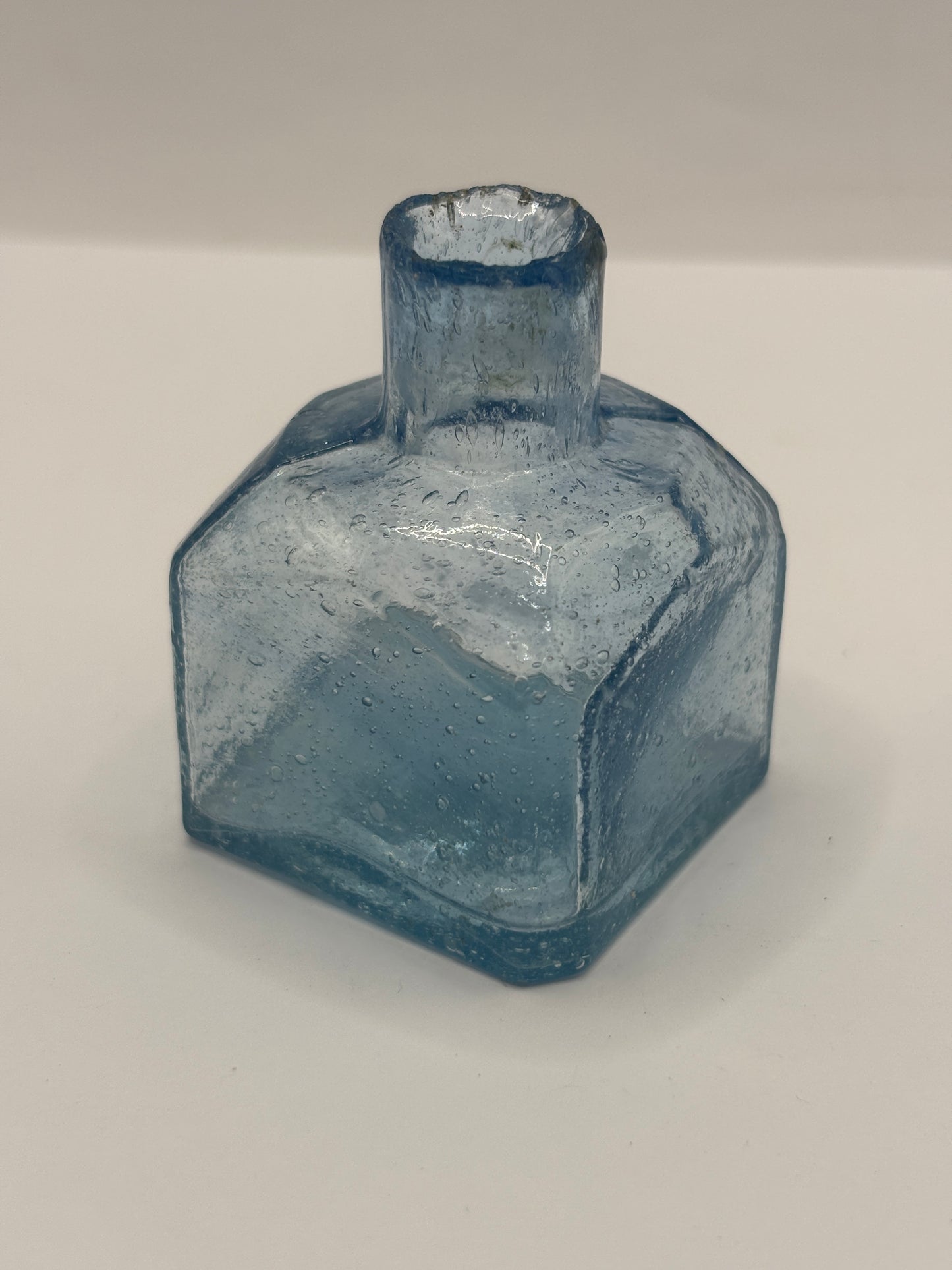 Old blue glass inkwell, ink bottle, penny ink. Lots of air bubbles