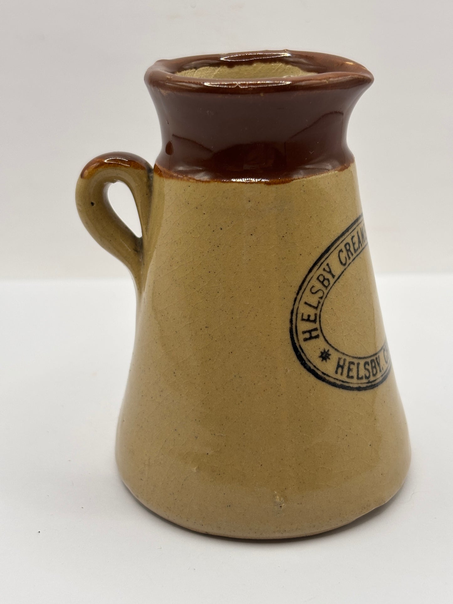 Old stoneware advertising cream pot, Helsby Creamery. Cheshire. Handled
