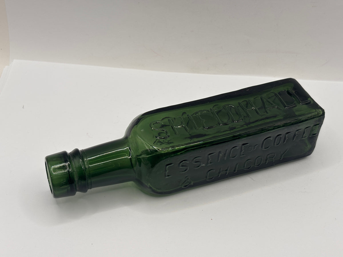 Old green glass essence of coffee bottle