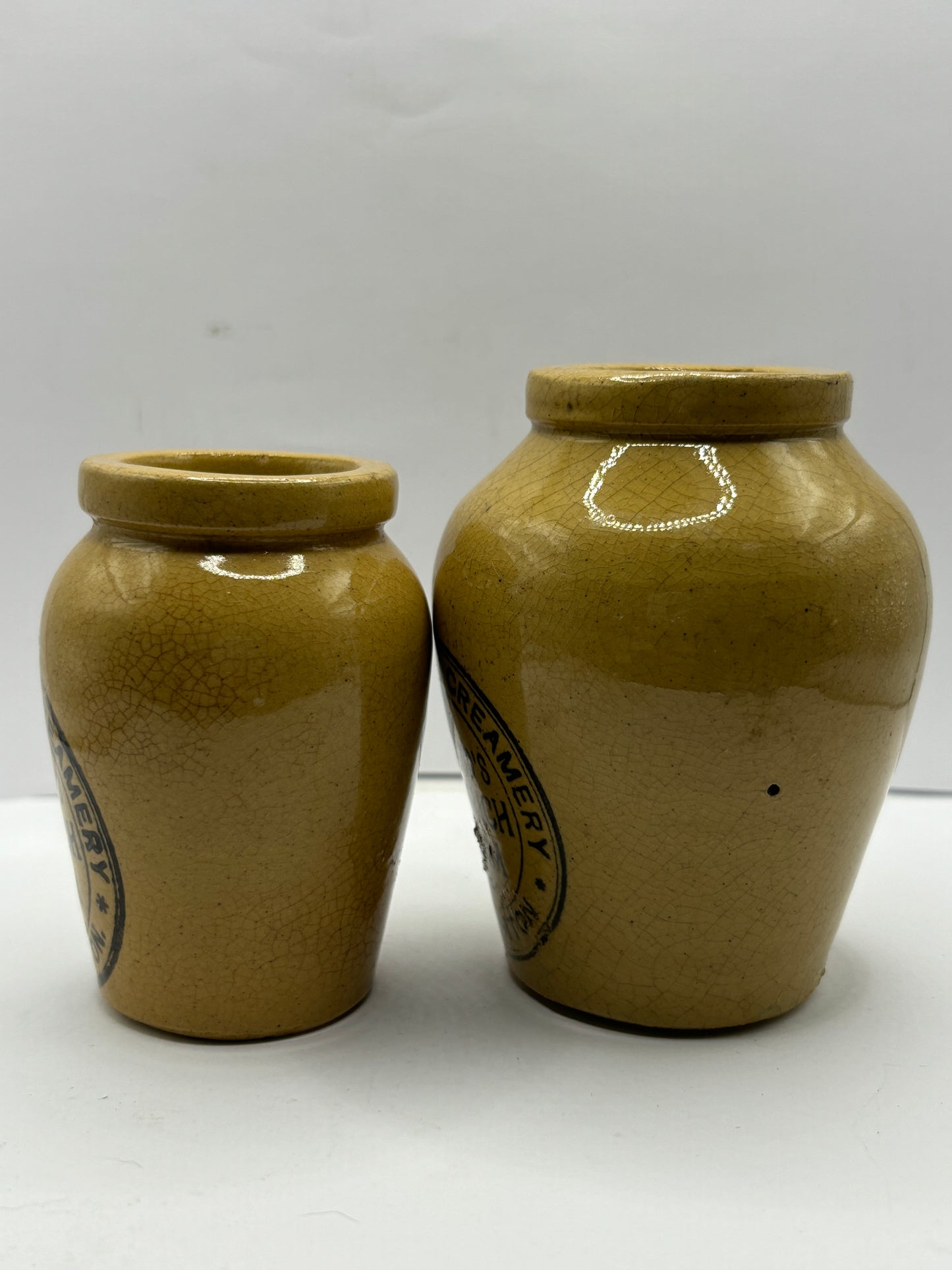 2 advertising cream pots, Stained & crazed