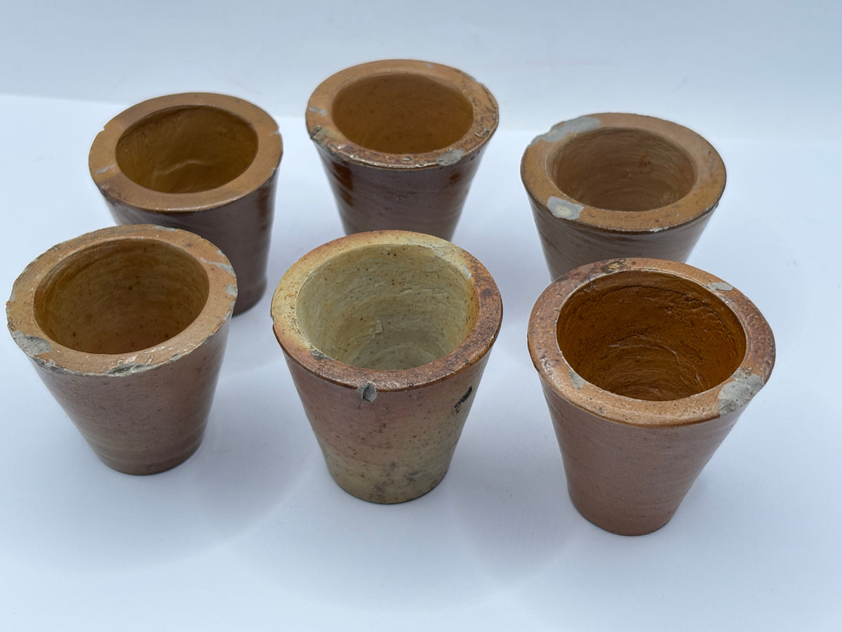 5 small brown stoneware pots. Chipped
