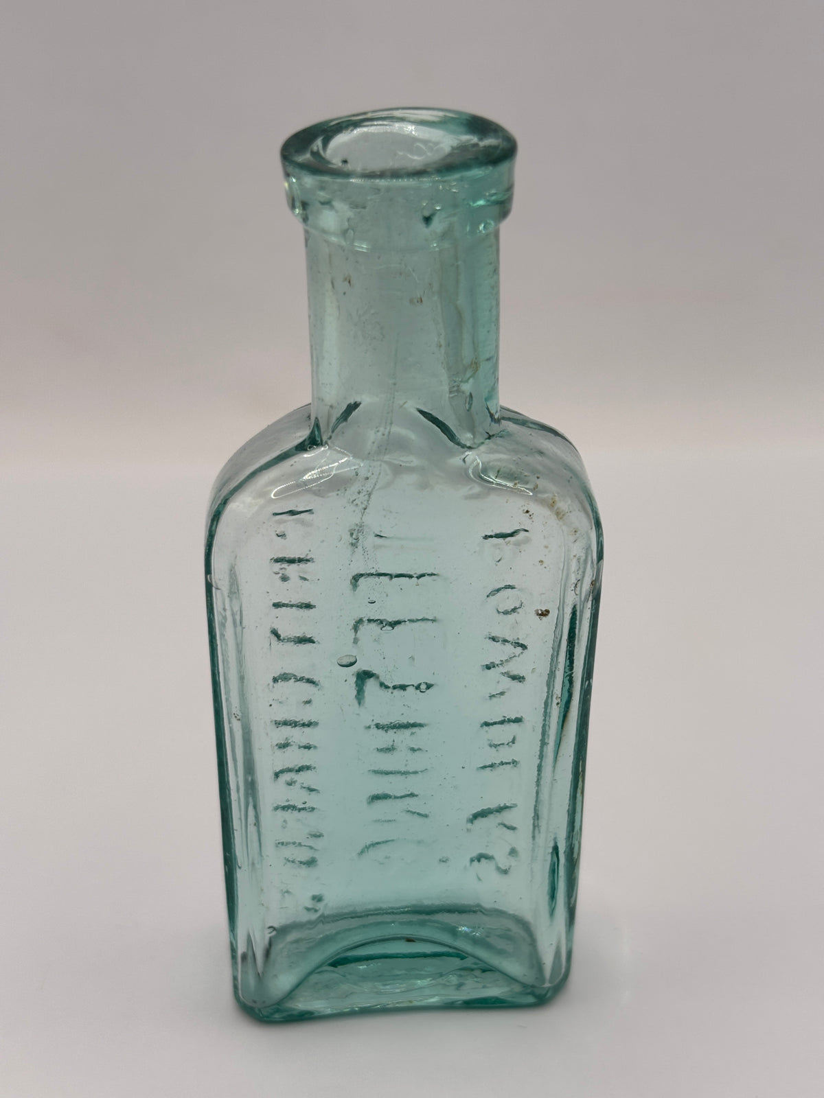 Old aqua glass advertising bottle. Try Pritchards teething powders