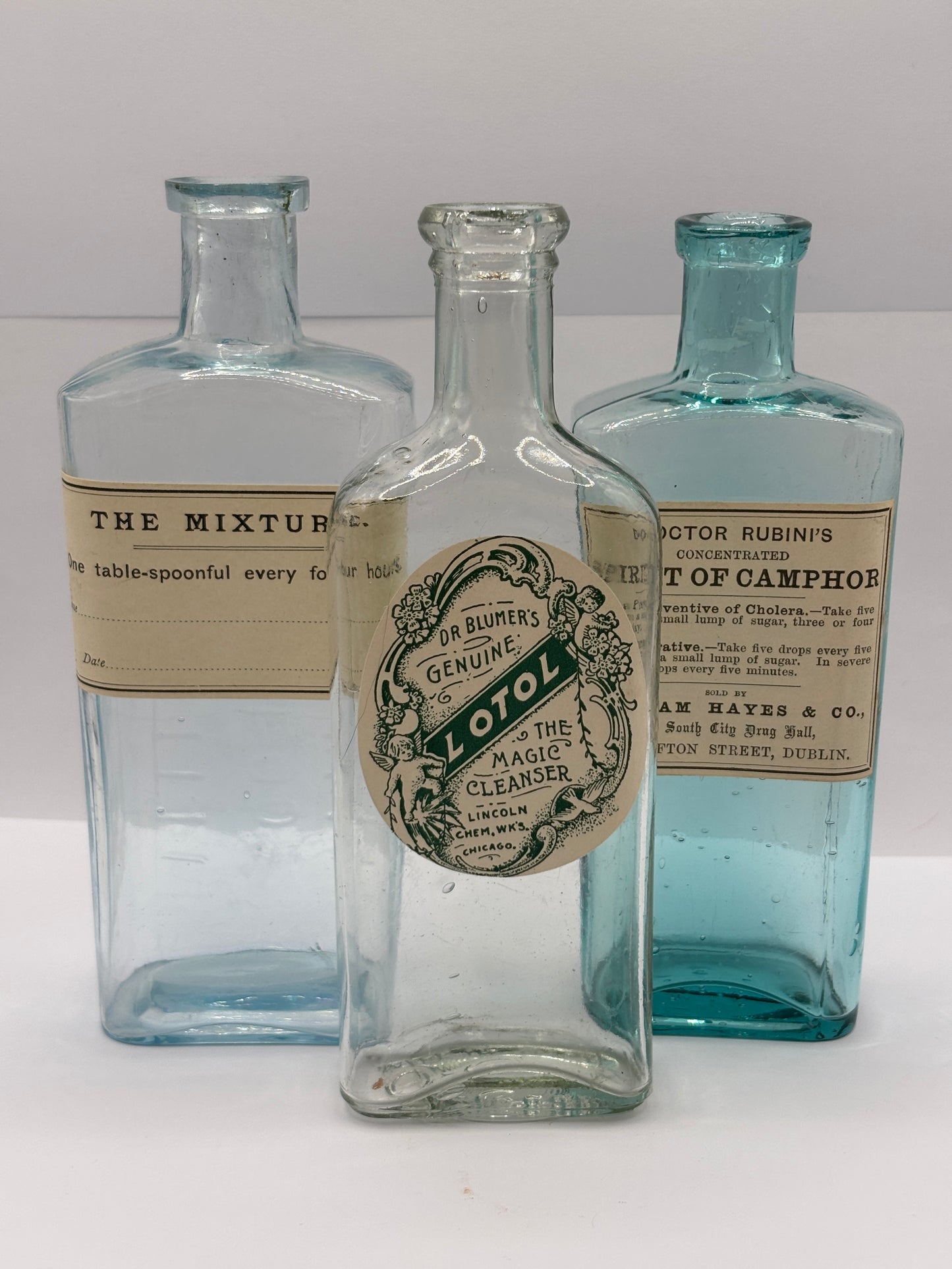 3 old chemist bottles with added labels