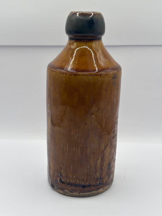 Old impressed stoneware ginger beer bottle, Manchester. Brown top
