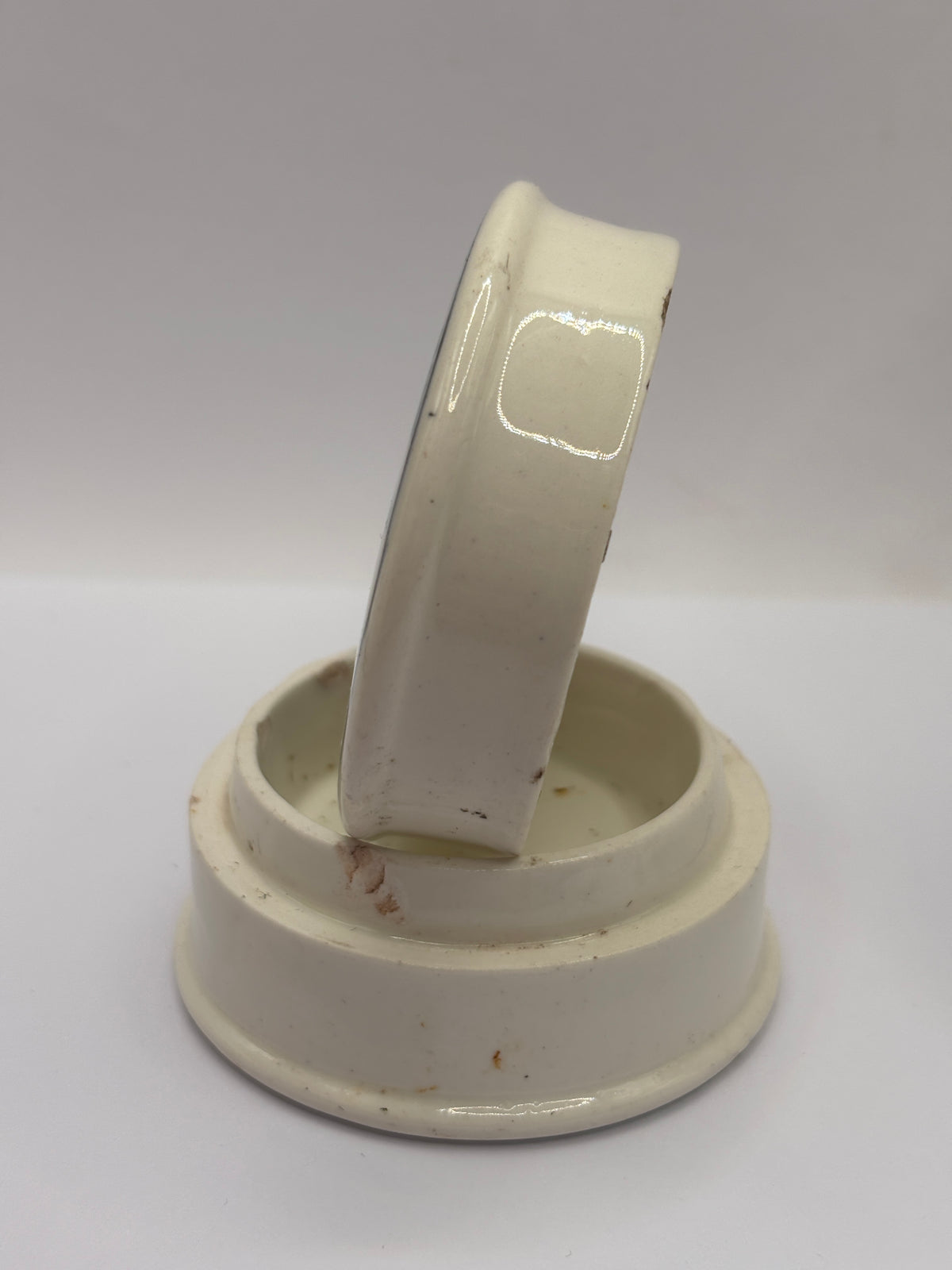 Old advertising lid and base. Woods areca nut tooth paste. Damaged