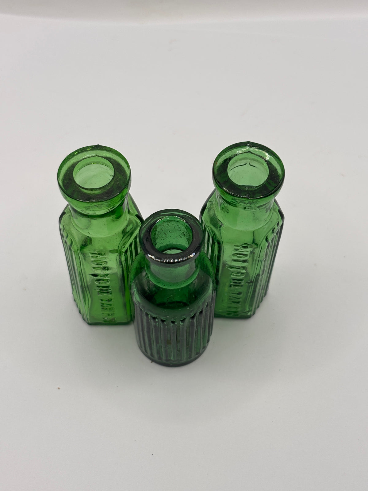 3 old small green ribbed poison bottles, not to be taken
