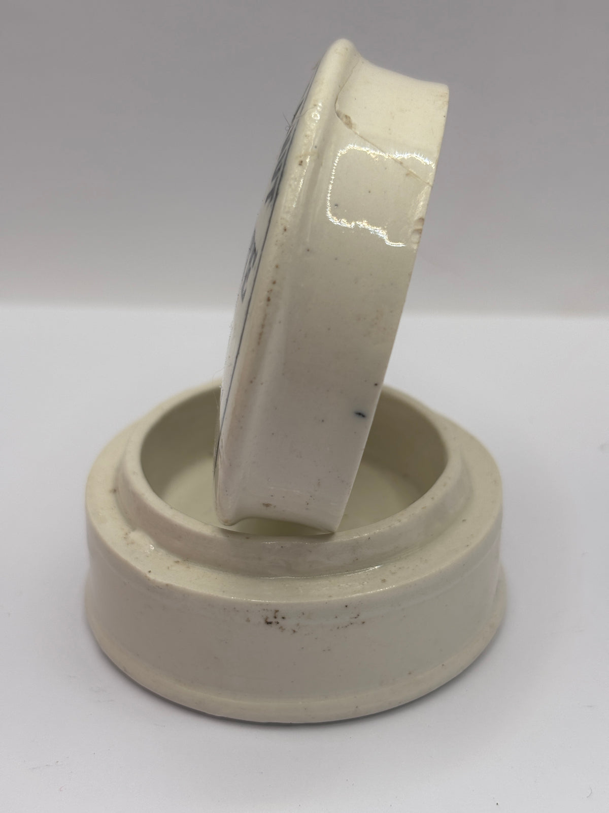 Old advertising lid and base. Woods areca nut tooth paste. Damaged