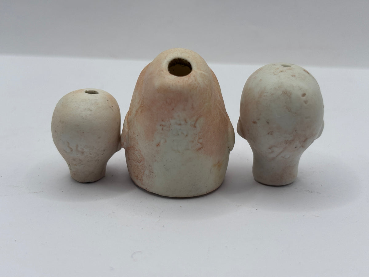 3 Old small bisque dolls heads